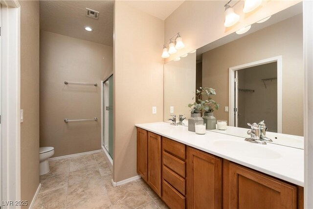2708 Cheer Pheasant Ave, North Las Vegas, NV 89084 - bathroom featuring double vanity, a shower stall, and a spacious closet