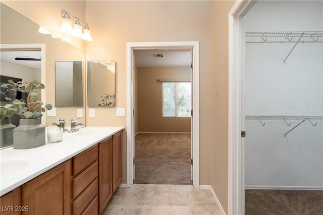 2708 Cheer Pheasant Ave, North Las Vegas, NV 89084 - bathroom with double vanity, a spacious closet, and baseboards