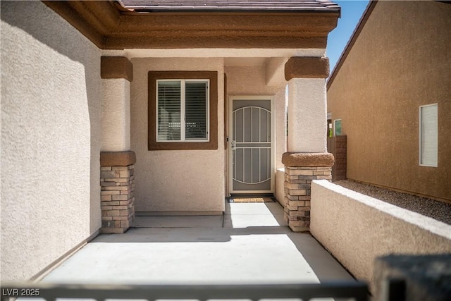 2708 Cheer Pheasant Ave, North Las Vegas, NV 89084 - doorway to property featuring stucco siding and stone siding
