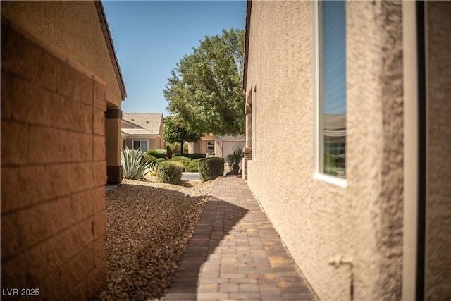 2708 Cheer Pheasant Ave, North Las Vegas, NV 89084 - view of side of property with stucco siding and a patio area
