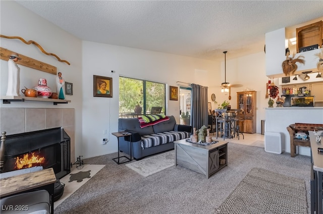 1575 W Warm Springs Rd Unit 2822, Henderson, NV 89014 - living room with a textured ceiling, carpet floors, a ceiling fan, and a fireplace