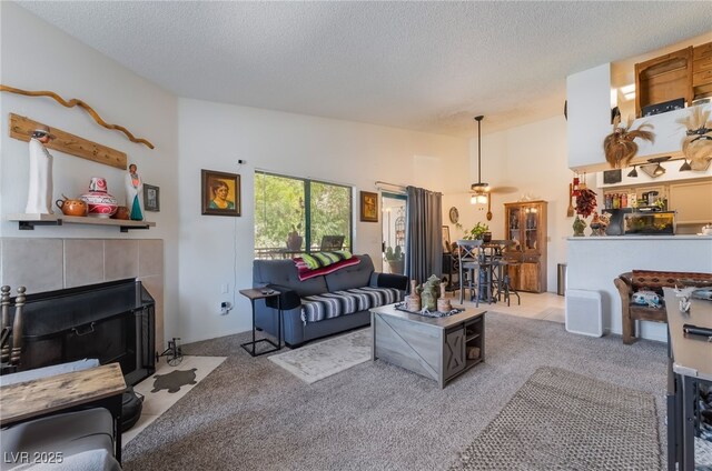 1575 W Warm Springs Rd Unit 2822, Henderson, NV 89014 - carpeted living area with a textured ceiling, ceiling fan, a fireplace, and vaulted ceiling