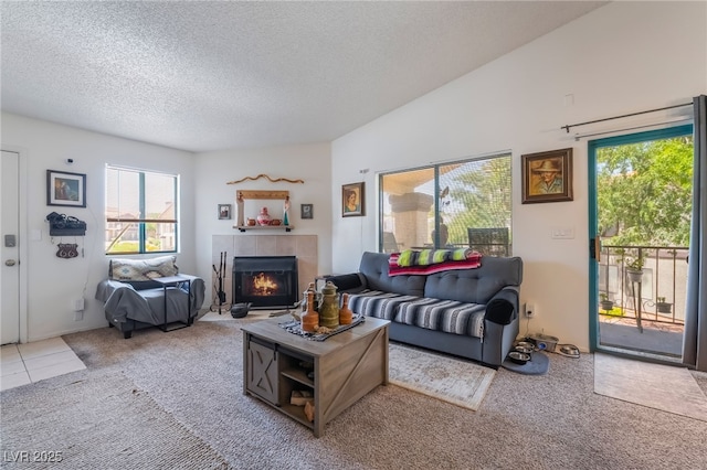1575 W Warm Springs Rd Unit 2822, Henderson, NV 89014 - living area featuring a textured ceiling, carpet floors, plenty of natural light, and a tiled fireplace