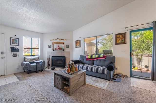 1575 W Warm Springs Rd Unit 2822, Henderson, NV 89014 - carpeted living area featuring healthy amount of natural light, a textured ceiling, and a tiled fireplace
