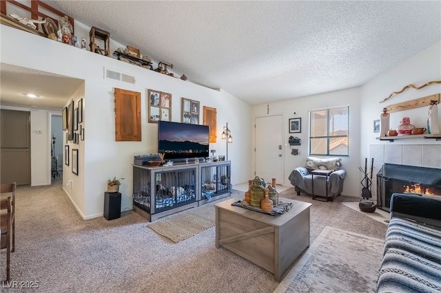 1575 W Warm Springs Rd Unit 2822, Henderson, NV 89014 - living room featuring a fireplace, carpet floors, and a textured ceiling