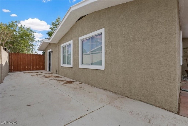 2408 Berkley Ave, Las Vegas, NV 89101 - view of side of home featuring stucco siding and a patio area