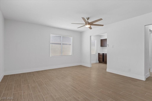 2408 Berkley Ave, Las Vegas, NV 89101 - spare room featuring a ceiling fan, light wood-type flooring, and baseboards
