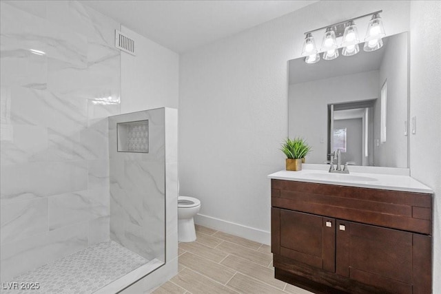 2408 Berkley Ave, Las Vegas, NV 89101 - full bathroom featuring vanity, toilet, a marble finish shower, and baseboards