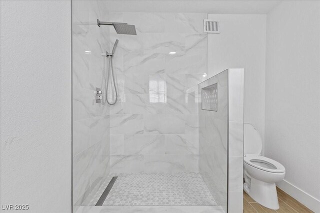 2408 Berkley Ave, Las Vegas, NV 89101 - full bath featuring toilet, a marble finish shower, and baseboards