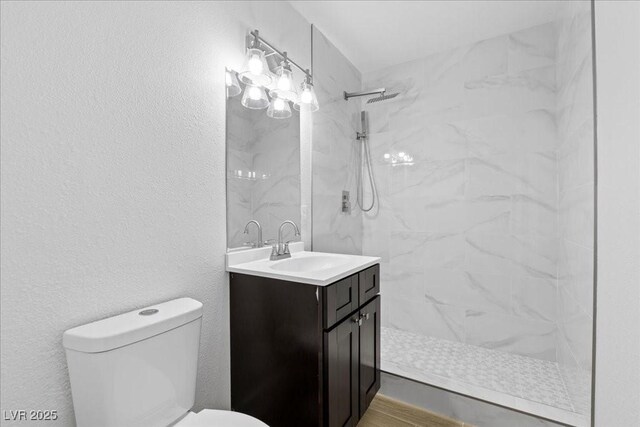 2408 Berkley Ave, Las Vegas, NV 89101 - bathroom with vanity, toilet, a marble finish shower, and wood finished floors