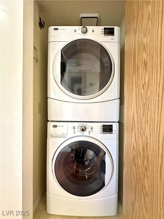 4151 Sanderling Cir Unit 351, Las Vegas, NV 89103 - laundry area with estacked washer and dryer and baseboards