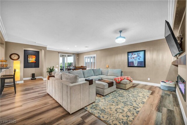 7029 Bocaire Dr, Las Vegas, NV 89131 - living area featuring crown molding, wood finished floors, baseboards, a fireplace, and recessed lighting