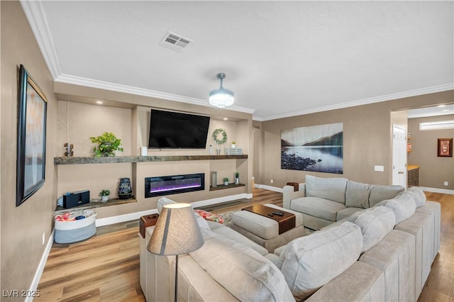 7029 Bocaire Dr, Las Vegas, NV 89131 - living area featuring wood finished floors, ornamental molding, baseboards, and a glass covered fireplace