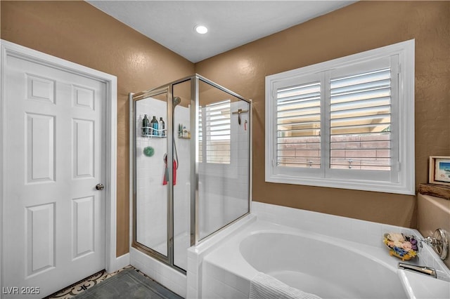 7029 Bocaire Dr, Las Vegas, NV 89131 - bathroom featuring a bath, a stall shower, and a textured wall