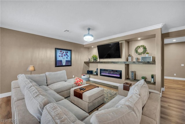 7029 Bocaire Dr, Las Vegas, NV 89131 - living area with baseboards, ornamental molding, wood finished floors, a glass covered fireplace, and recessed lighting