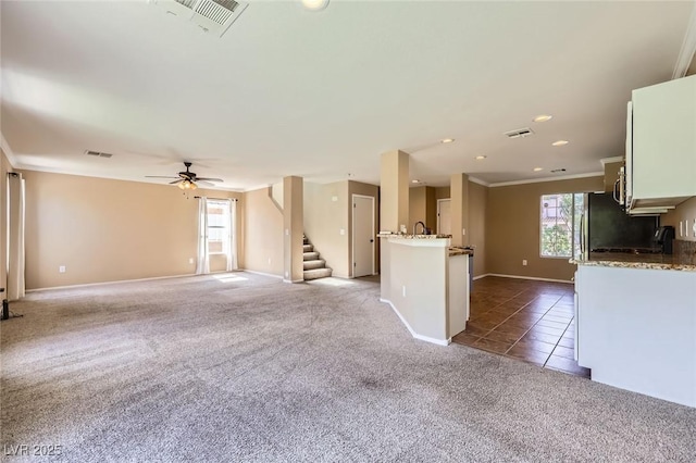 7382 Elbridge Way, Las Vegas, NV 89113 - unfurnished living room featuring carpet floors, ornamental molding, a ceiling fan, baseboards, and stairs