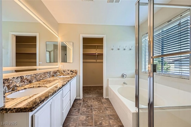 7382 Elbridge Way, Las Vegas, NV 89113 - full bathroom with double vanity, a spacious closet, a bath, and a shower stall