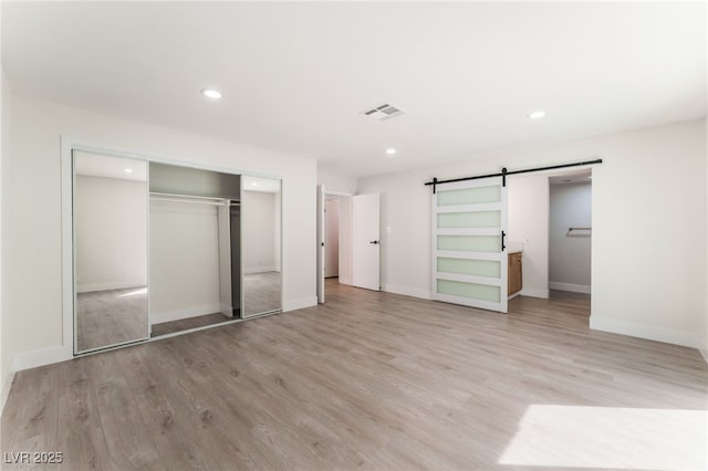 3409 El Cortez Ave, Las Vegas, NV 89102 - unfurnished bedroom with a barn door, a closet, light wood finished floors, recessed lighting, and baseboards