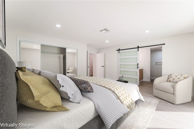 3409 El Cortez Ave, Las Vegas, NV 89102 - bedroom with light wood-style floors, a barn door, a closet, and recessed lighting