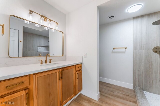 3409 El Cortez Ave, Las Vegas, NV 89102 - bathroom featuring walk in shower, vanity, wood finished floors, and baseboards