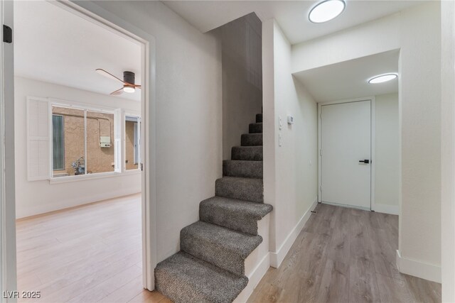 3409 El Cortez Ave, Las Vegas, NV 89102 - stairs featuring wood finished floors, a ceiling fan, and baseboards