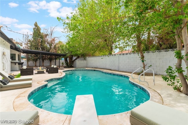 3409 El Cortez Ave, Las Vegas, NV 89102 - view of pool with an outdoor living space, a patio, a fenced backyard, and a diving board