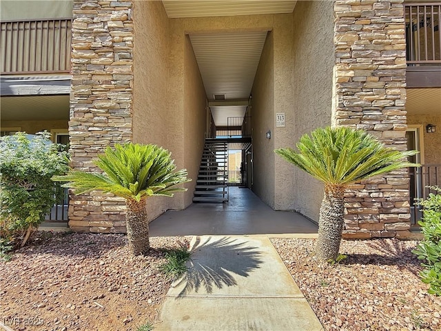 4943 Indian River Dr Unit 133, Las Vegas, NV 89103 - doorway to property with stucco siding and stone siding