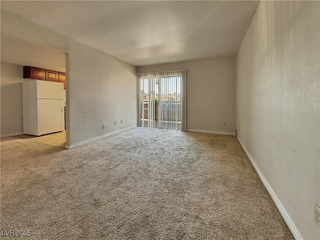4943 Indian River Dr Unit 133, Las Vegas, NV 89103 - unfurnished room featuring a textured wall, light colored carpet, and baseboards