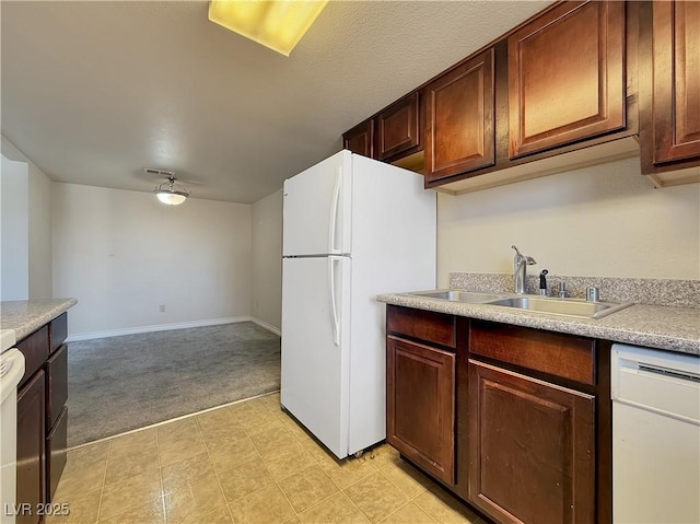 4943 Indian River Dr Unit 133, Las Vegas, NV 89103 - kitchen with white appliances, light carpet, a sink, light countertops, and baseboards