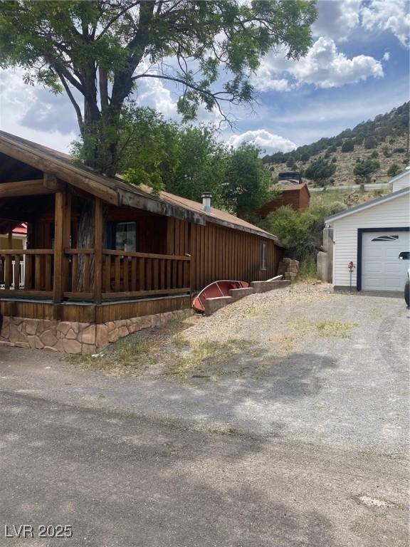 631 Mccannon St, Pioche, NV 89043 - view of yard with a mountain view and a garage