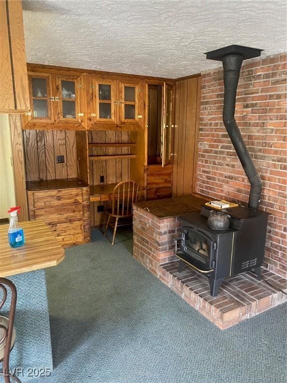 631 Mccannon St, Pioche, NV 89043 - carpeted living area featuring a wood stove and a textured ceiling