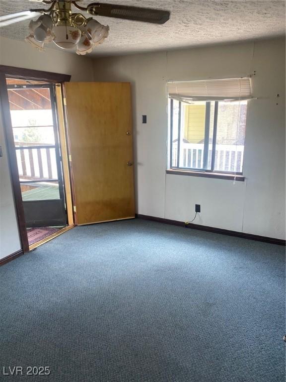 631 Mccannon St, Pioche, NV 89043 - carpeted spare room featuring plenty of natural light, ceiling fan, a textured ceiling, and baseboards