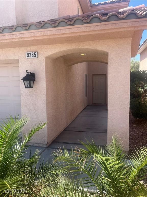 9365 Sparkling Waters Ave, Las Vegas, NV 89129 - doorway to property with stucco siding