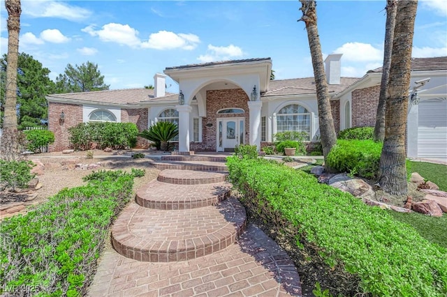 4418 Desert Bloom Ct, Las Vegas, NV 89129 - mediterranean / spanish house with a chimney and brick siding