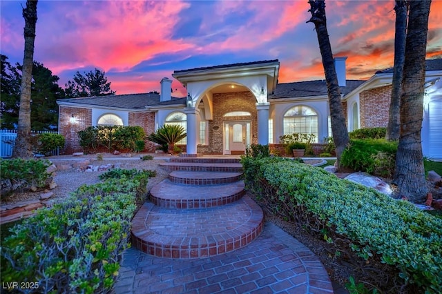 4418 Desert Bloom Ct, Las Vegas, NV 89129 - view of front of home featuring brick siding and a chimney