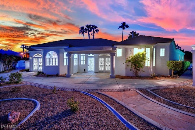 4418 Desert Bloom Ct, Las Vegas, NV 89129 - rear view of property featuring driveway, stucco siding, and french doors