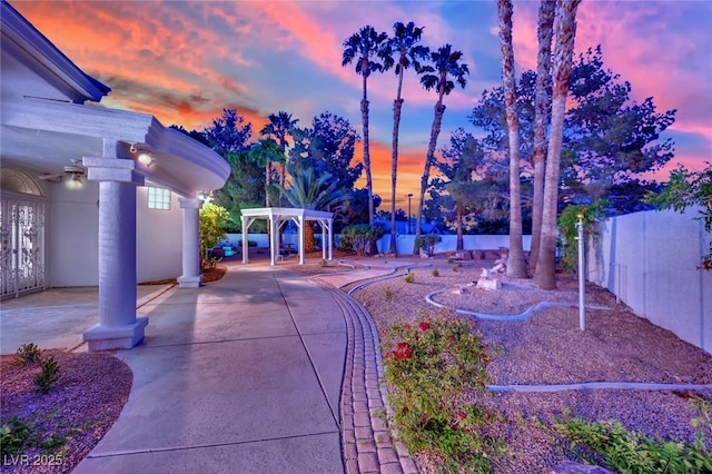 4418 Desert Bloom Ct, Las Vegas, NV 89129 - yard at dusk featuring a patio area and a pergola