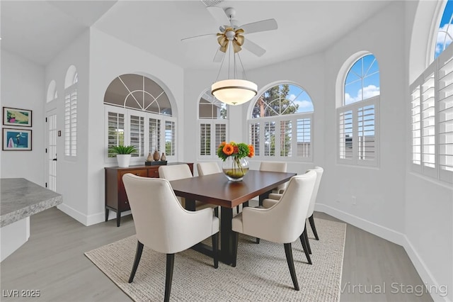 4418 Desert Bloom Ct, Las Vegas, NV 89129 - dining area featuring light wood-style flooring, healthy amount of natural light, baseboards, and ceiling fan