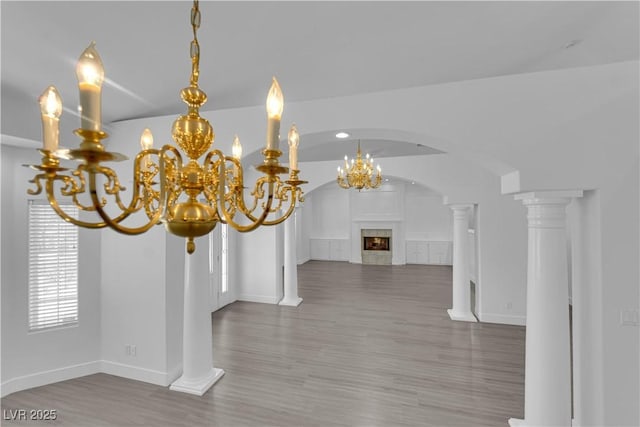 4418 Desert Bloom Ct, Las Vegas, NV 89129 - detailed view of wood finished floors, a high end fireplace, a chandelier, baseboards, and arched walkways