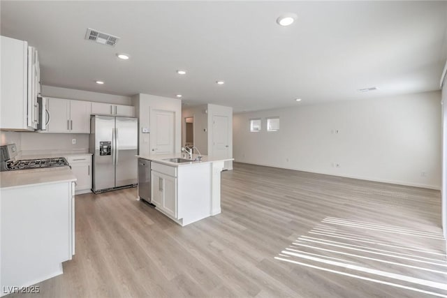 1425 Gable Falls Dr Unit 93, North Las Vegas, NV 89084 - kitchen with stainless steel appliances, a sink, light wood-type flooring, light countertops, and open floor plan