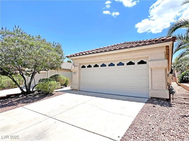 2119 Sunset Vista Ave, Henderson, NV 89052 - view of front of property with a tiled roof, stucco siding, and a detached garage
