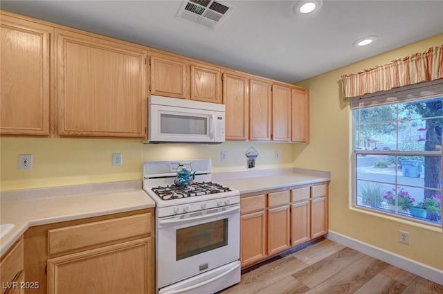622 Quaint Acres Ave, Las Vegas, NV 89183 - kitchen featuring white appliances, light countertops, light wood finished floors, light brown cabinetry, and baseboards
