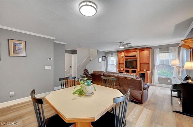 622 Quaint Acres Ave, Las Vegas, NV 89183 - dining area with ornamental molding, light wood finished floors, ceiling fan, baseboards, and stairs