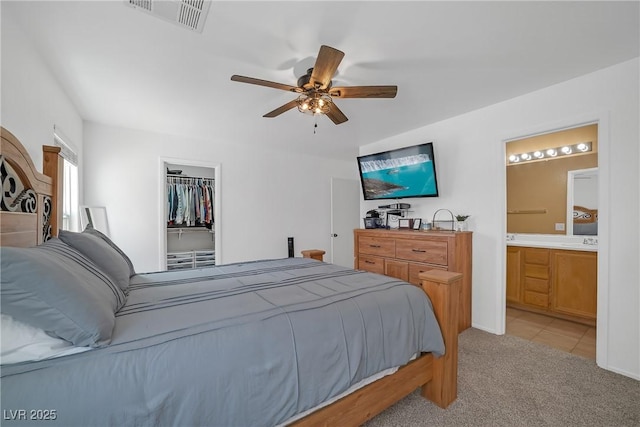 8320 Highland Ranch St, Las Vegas, NV 89131 - bedroom featuring light colored carpet, connected bathroom, a spacious closet, a closet, and a ceiling fan