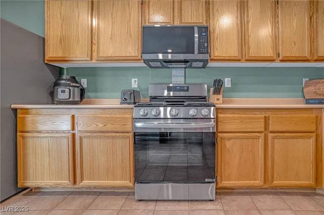 8320 Highland Ranch St, Las Vegas, NV 89131 - kitchen featuring stainless steel appliances, light countertops, and light tile patterned flooring