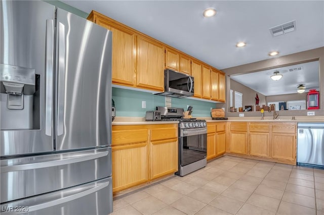 8320 Highland Ranch St, Las Vegas, NV 89131 - kitchen featuring appliances with stainless steel finishes, light countertops, a sink, recessed lighting, and light tile patterned floors