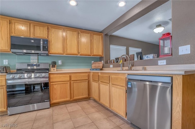 8320 Highland Ranch St, Las Vegas, NV 89131 - kitchen with appliances with stainless steel finishes, light tile patterned floors, light countertops, a sink, and recessed lighting