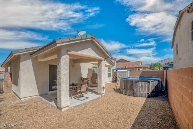 8320 Highland Ranch St, Las Vegas, NV 89131 - rear view of house with stucco siding, a fenced backyard, and a patio area