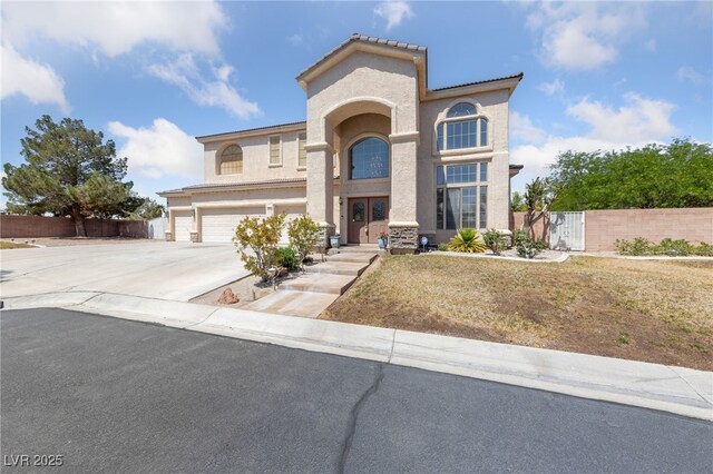 4883 Grey Mesa St, Las Vegas, NV 89149 - view of front facade featuring stucco siding, driveway, an attached garage, and a gate
