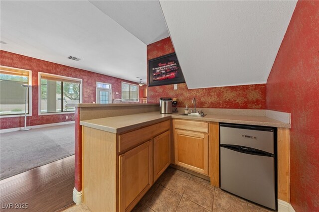 4883 Grey Mesa St, Las Vegas, NV 89149 - kitchen featuring dishwasher, a sink, light countertops, a peninsula, and open floor plan